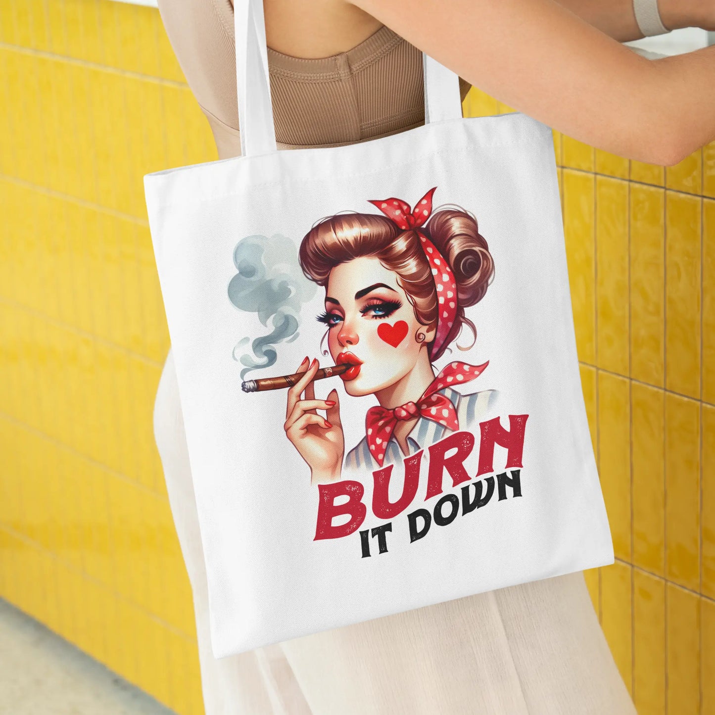 White tote bag with a bold retro pin-up girl smoking a cigar and red text that says:
"BURN IT DOWN"