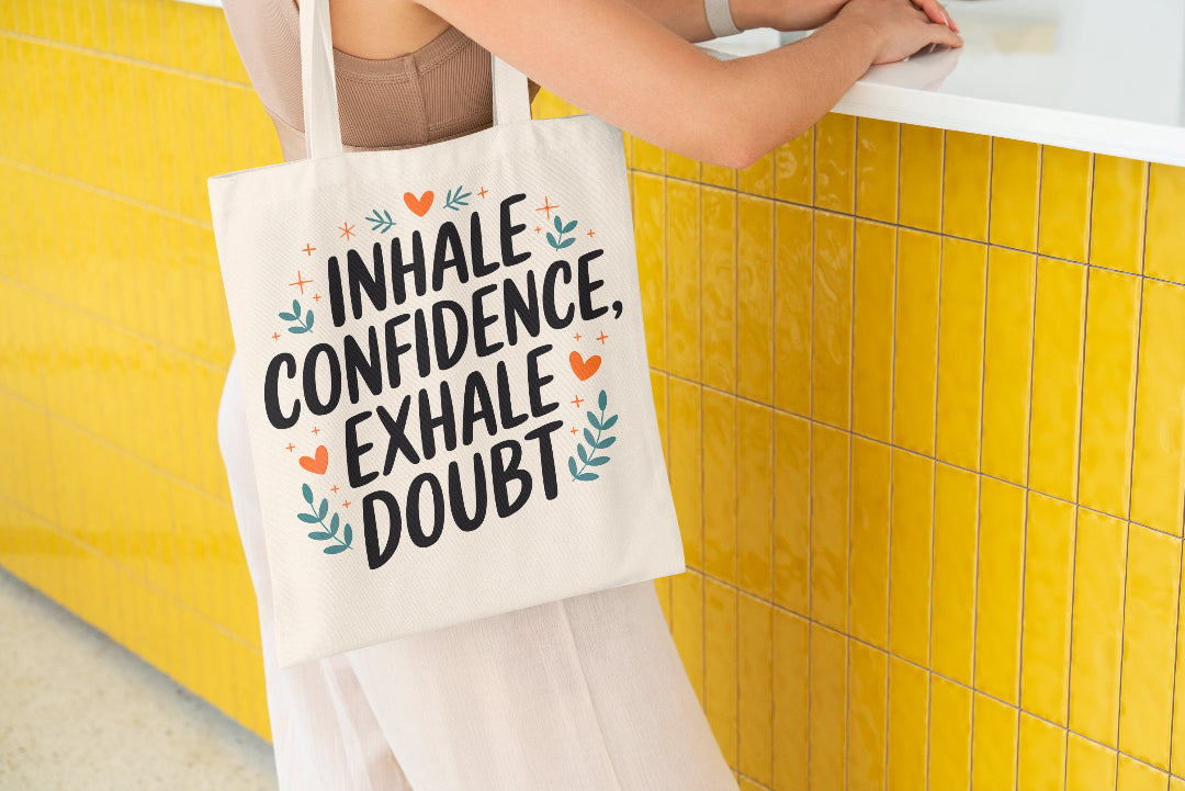 Motivational tote bag with the quote 'Inhale Confidence, Exhale Doubt' and decorative elements.