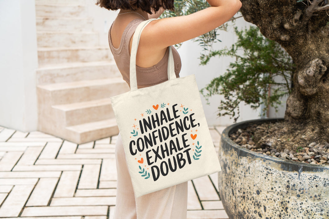 Motivational tote bag with the quote 'Inhale Confidence, Exhale Doubt' and decorative elements.