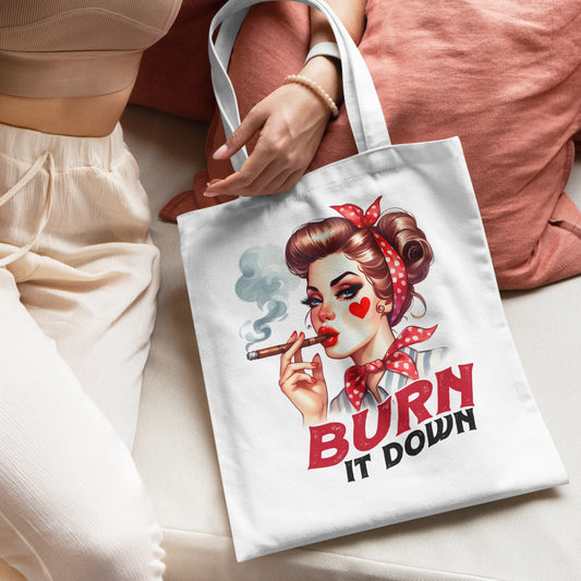 White tote bag featuring a glamorous retro woman with a wine glass and rotary phone.
Text reads: "She Was a Maven of Bullshit"